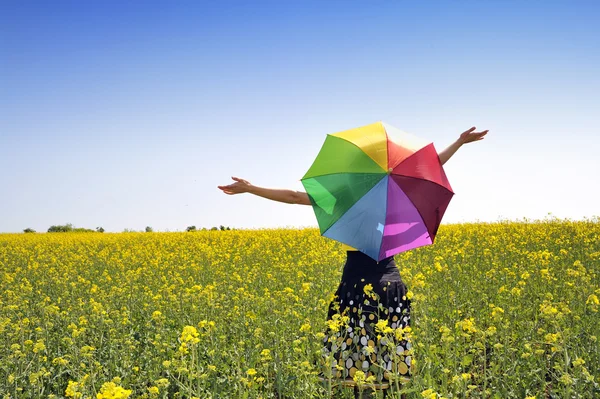Girl on fileld with umbrella — Stock Photo, Image