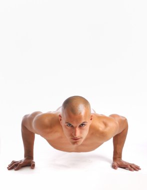 Young man doing a pushup clipart