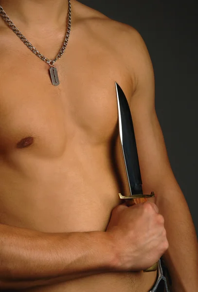 Man holding knife on a torso — Stock Photo, Image