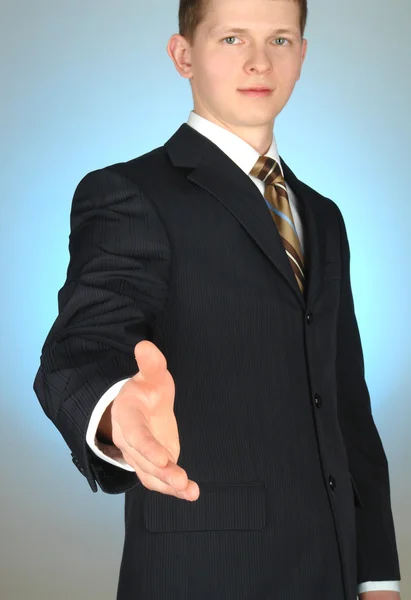 Jonge zakenman bedrijf hand — Stockfoto