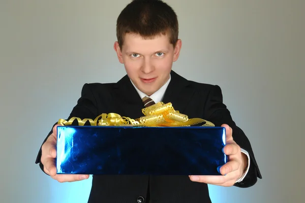 Businessman with blue box present — Stock Photo, Image
