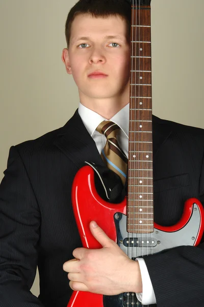 Businessman with red electro guitar — Stock Photo, Image