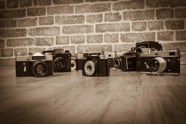 Câmeras antigas em uma foto velha de madeira — Fotografia de Stock