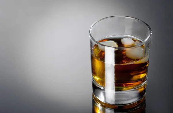 Glass whisky on a grey bg — Stock Photo, Image