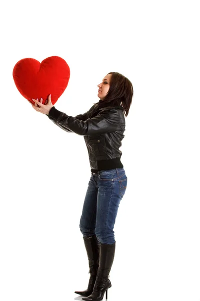 Rockergirl with red heart pillow — Stock Photo, Image