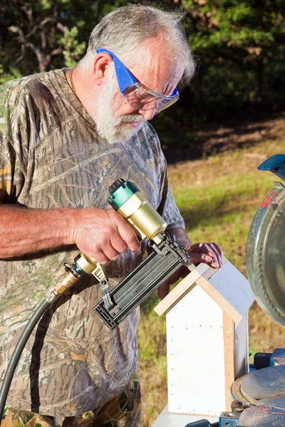 stock image Senior Man Building a Bird House