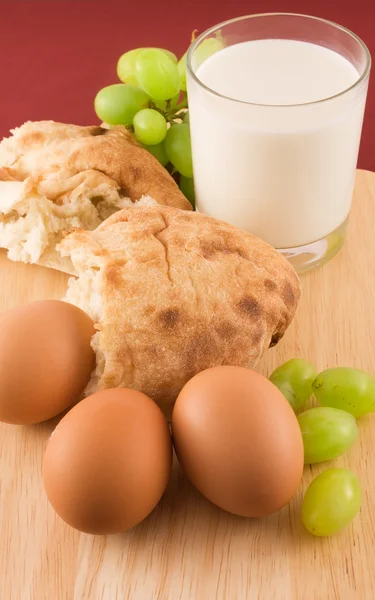 stock image Fresh bread with eggs and glass of milk