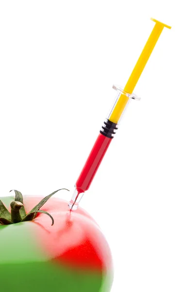 Syringe Injecting Red Liquid Into a Green Tomato — Stock Photo, Image