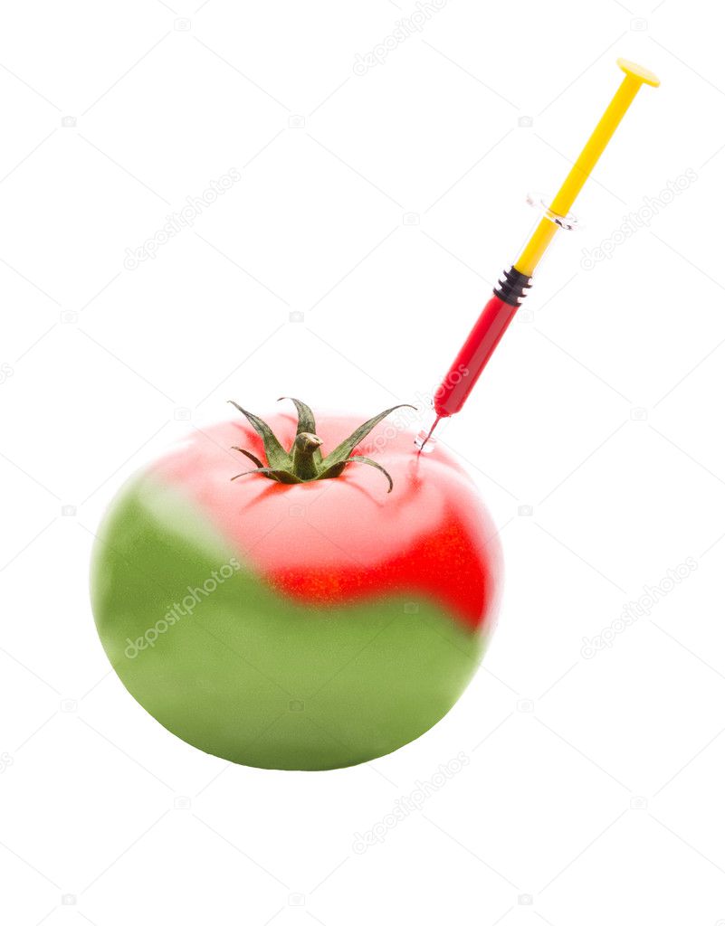 Syringe Injecting Red Liquid Into a Green Tomato