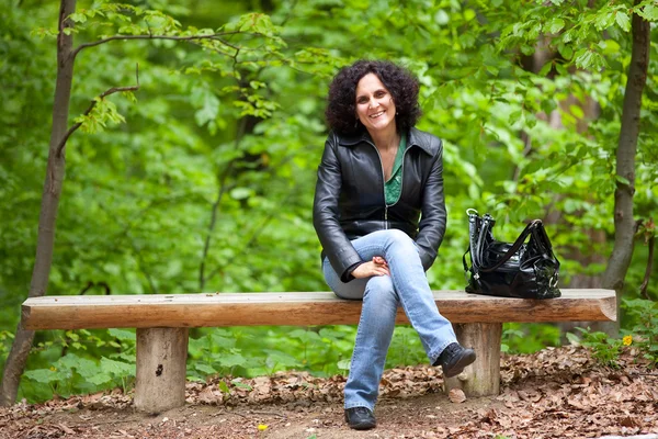 Young lady sitting on bench — Stock Photo, Image