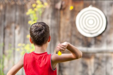 Child playing darts clipart