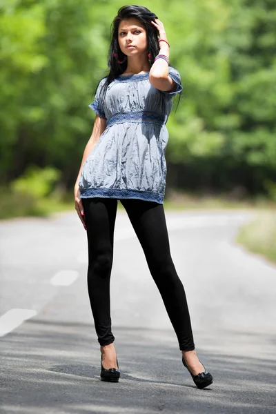 Young lady standing in the street — Stock Photo, Image