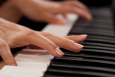 Piano player closeup on hands clipart