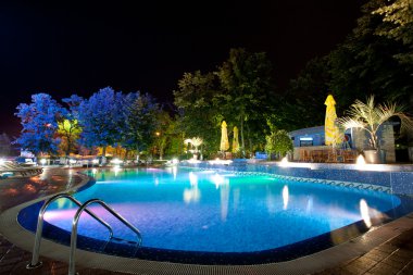 Hotel pool at night clipart