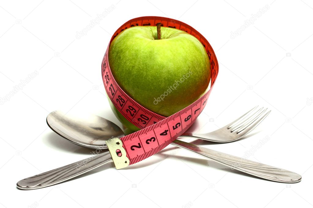 Spoon fork and apple is strung by a ribbon for measuring diet