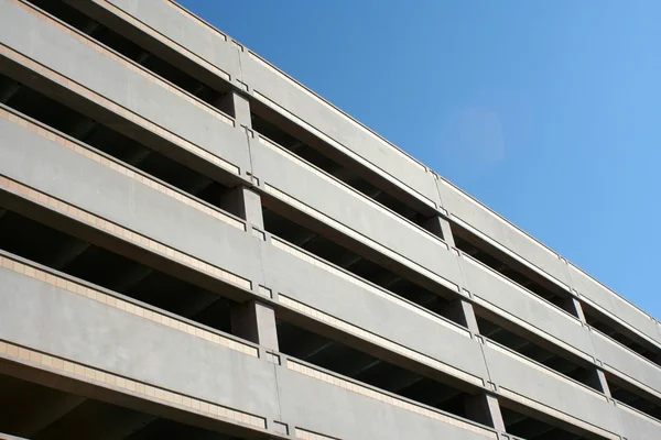 stock image A tall parking deck against blue sky