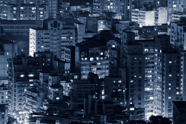 Night scene of buildings illuminated in modern city.