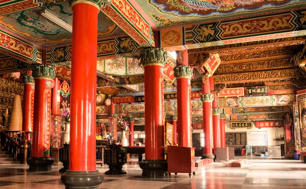 Building interior of colorful China temple with carving and inscription.