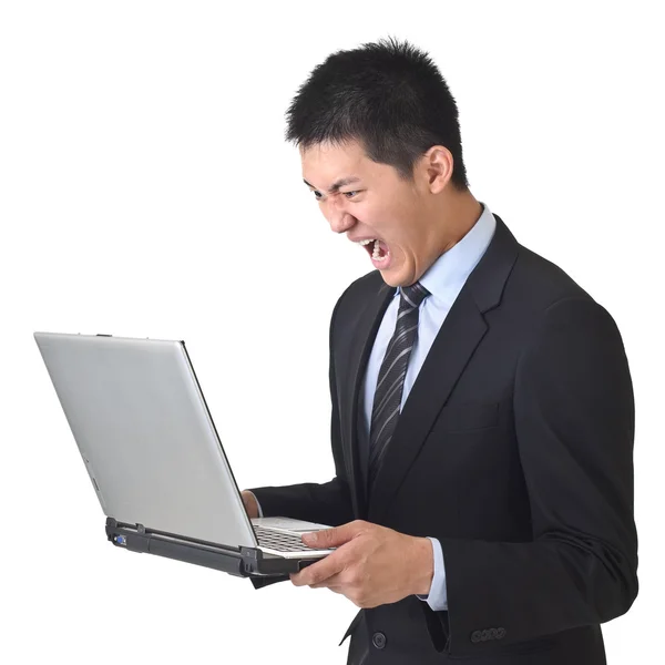 Homme d'affaires en colère tenant ordinateur portable — Photo