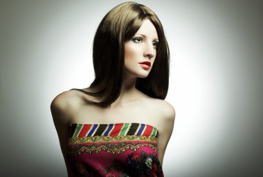 Fashion portrait of the young woman in studio clipart