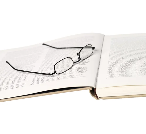 Glasögon i en spridning bok — Stockfoto