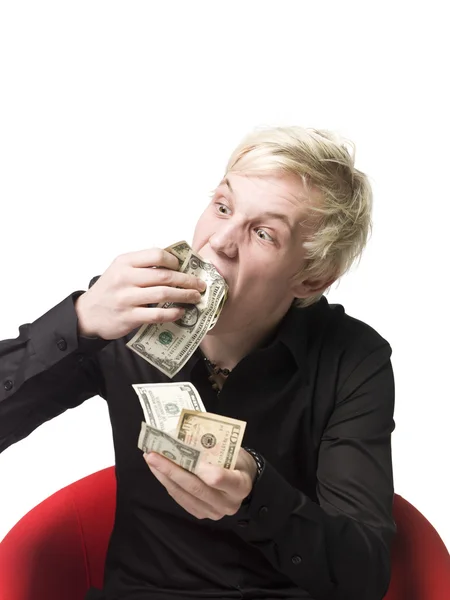 Homem comendo dinheiro — Fotografia de Stock