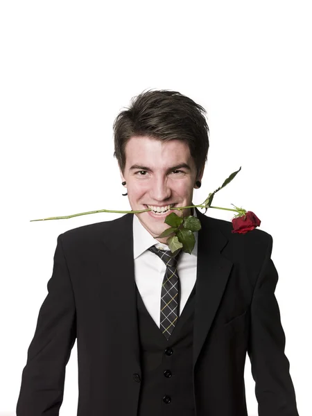 Hombre con una rosa en la boca — Foto de Stock