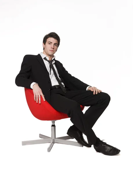 Man in red armchair — Stock Photo, Image
