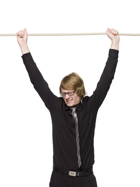 Человек, висящий на веревке — стоковое фото