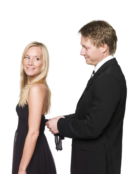 Man helping woman to get dressed — Stock Photo, Image