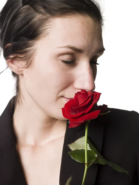 stock image Woman smells a rose