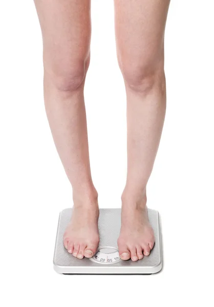 Standing on a weightscale — Stock Photo, Image