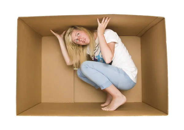 Mulher dentro de uma caixa de papelão — Fotografia de Stock
