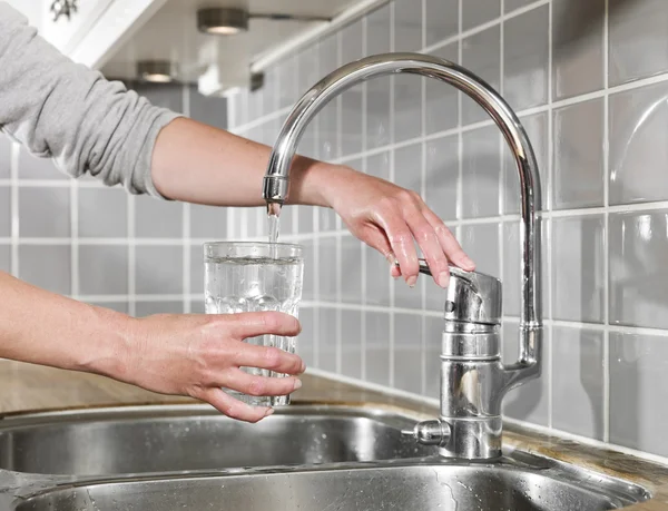 Filling a glass of water — Stock Photo, Image