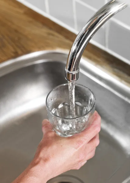 Filling a glass of water — Stock Photo, Image