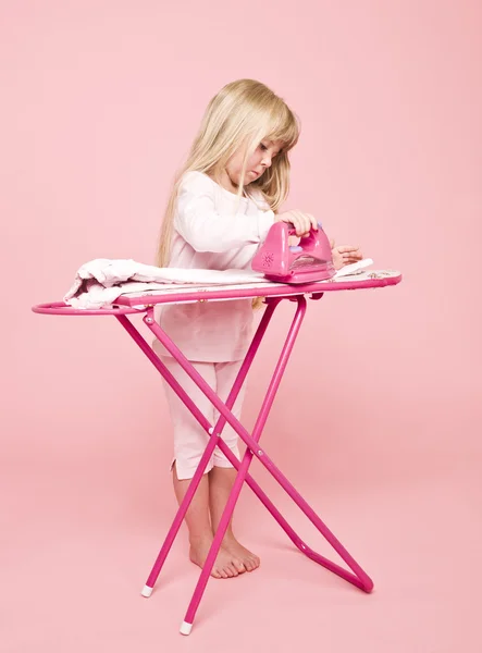 Little girl ironing dress — Stock Photo, Image