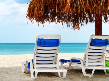 Two empty chairs by the sea clipart