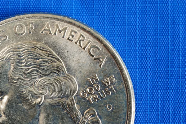 In God We Trust from the quarter isolated on blue — Stock Photo, Image