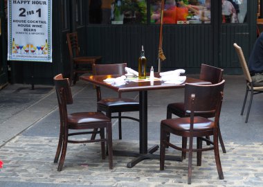 Empty dinning tables in an outdoor restaurant clipart