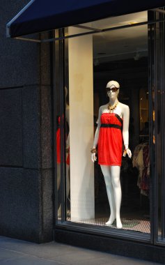 A view of the display window from a clothing store clipart