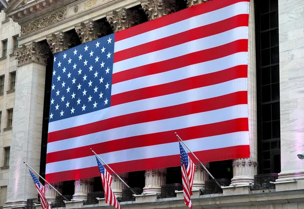 stock image A giant American flag hanging in Wall Street