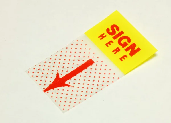 Close-up van het teken hier sticker — Stockfoto