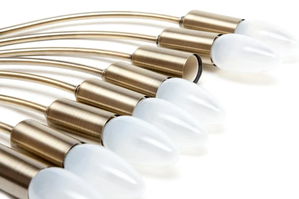 Elektriska glödlampor i gyllene beskyddare — Stockfoto