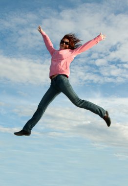 Girl in jump on background sky clipart