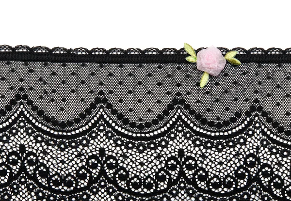 Black lace with rose satin flower on white background