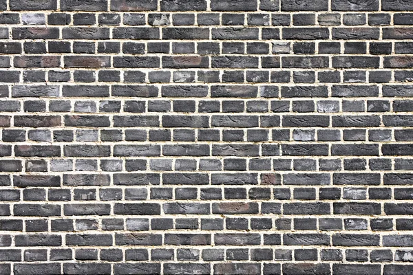 Schwarze Ziegelmauer — Stockfoto