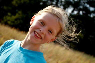 Children on a meadow clipart