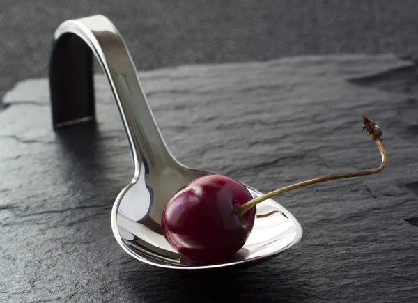 Cherry on spoon — Stock Photo, Image