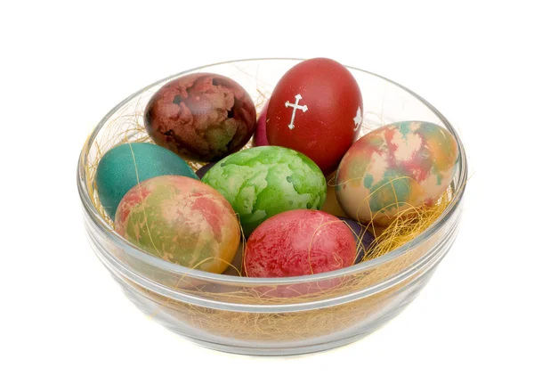 Varicoloured húsvéti tojás egy üveg Stock Kép