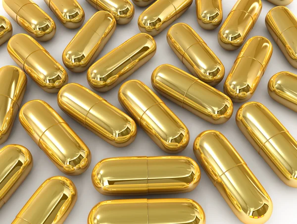 Gold pill capsule — Stock Photo, Image